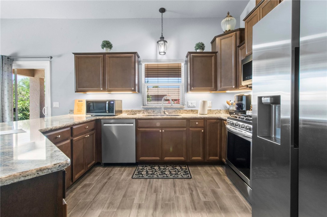 3897 Easy Street Kingman, AZ 86409 - Photo 13 of 53 a kitchen with stainless steel appliances granite countertop a sink a stove and a refrigerator