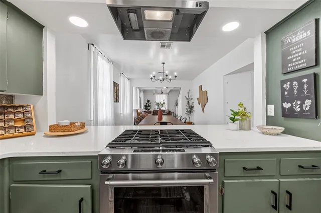 a kitchen with a stove and cabinets