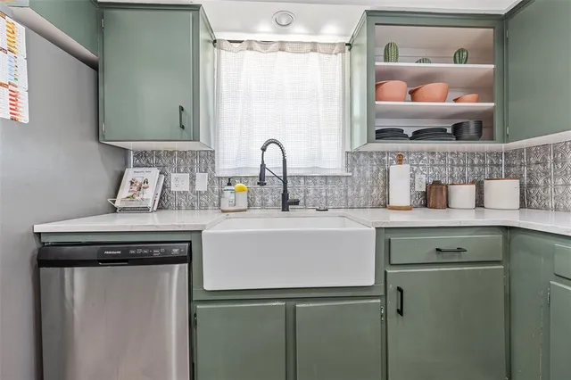 a view of a kitchen with a sink and a refrigerator