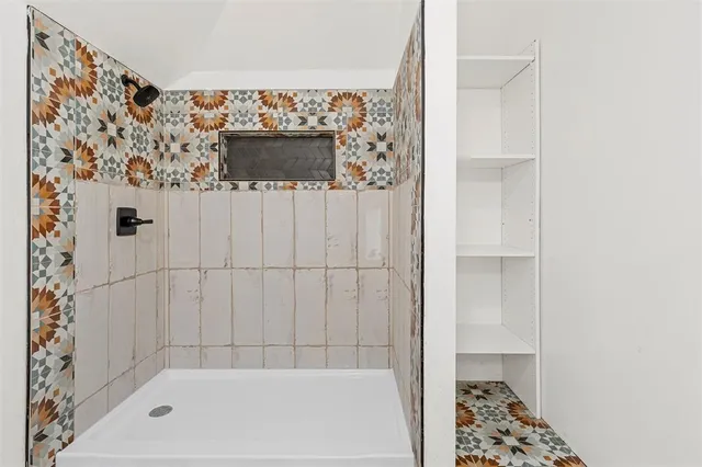a view of storage and utility room with wooden floor washer and dryer