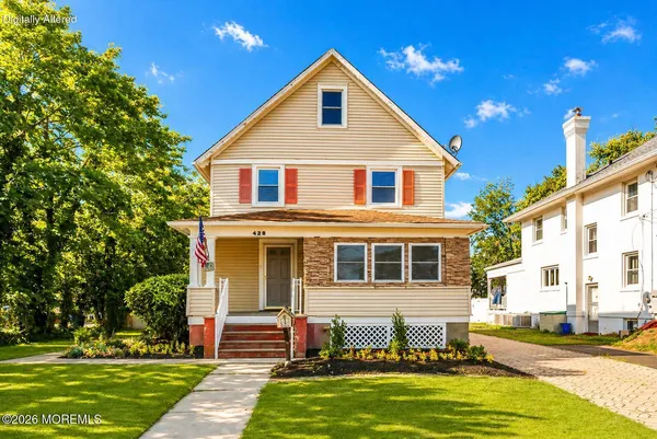 a front view of a house with a yard