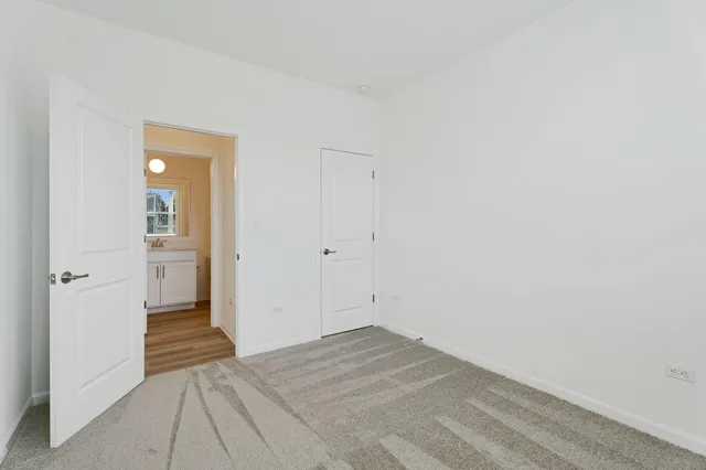 a view of a room with wooden floor and a bathroom