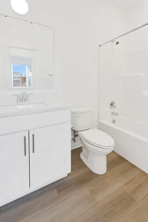 a white toilet sitting next to a bathroom sink