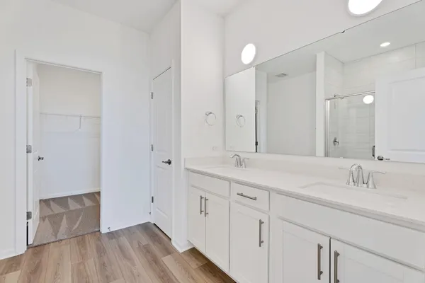 a bathroom with a double vanity sink and mirror