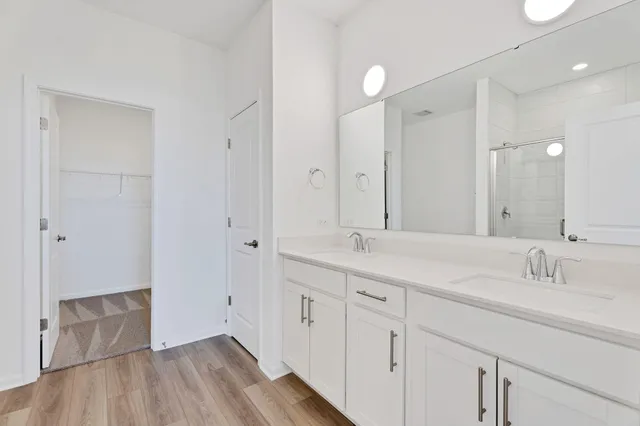 a bathroom with a double vanity sink and mirror