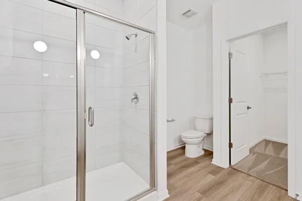 a bathroom with a granite countertop toilet a sink and shower