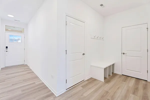 a view of an empty room with wooden floor