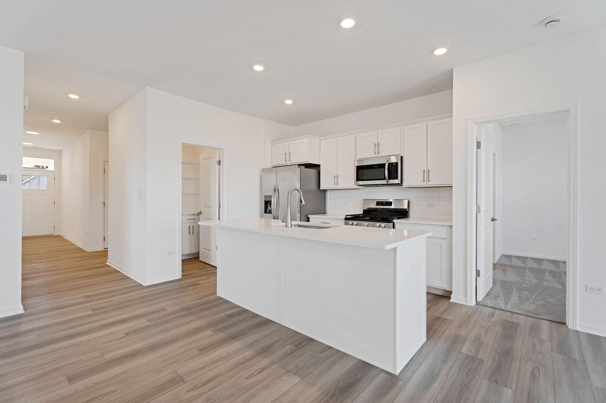481 East 127th Lane Crown Point, IN 46307 - Photo 4 of 29 a kitchen with a refrigerator and a stove top oven