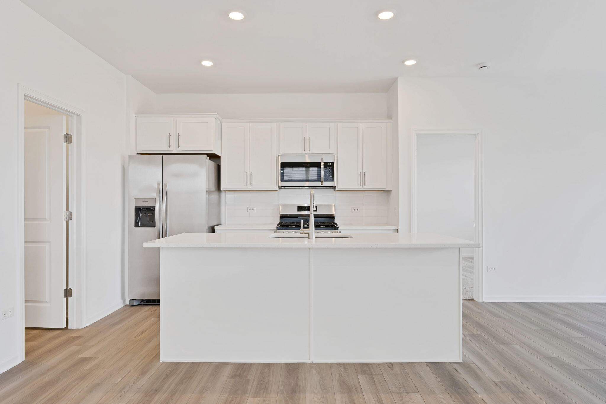 481 East 127th Lane Crown Point, IN 46307 - Photo 5 of 29 a kitchen with stainless steel appliances a microwave a sink and a refrigerator