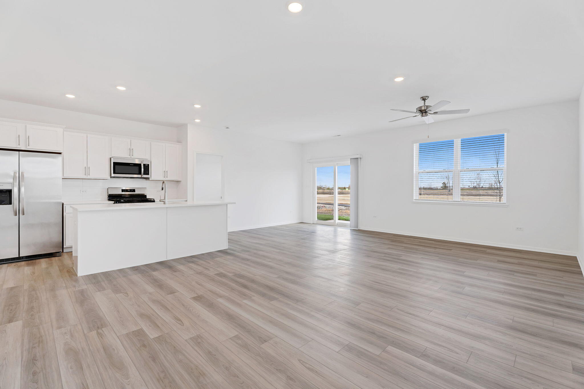 481 East 127th Lane Crown Point, IN 46307 - Photo 6 of 29 a view of a kitchen with wooden floor and electronic appliances
