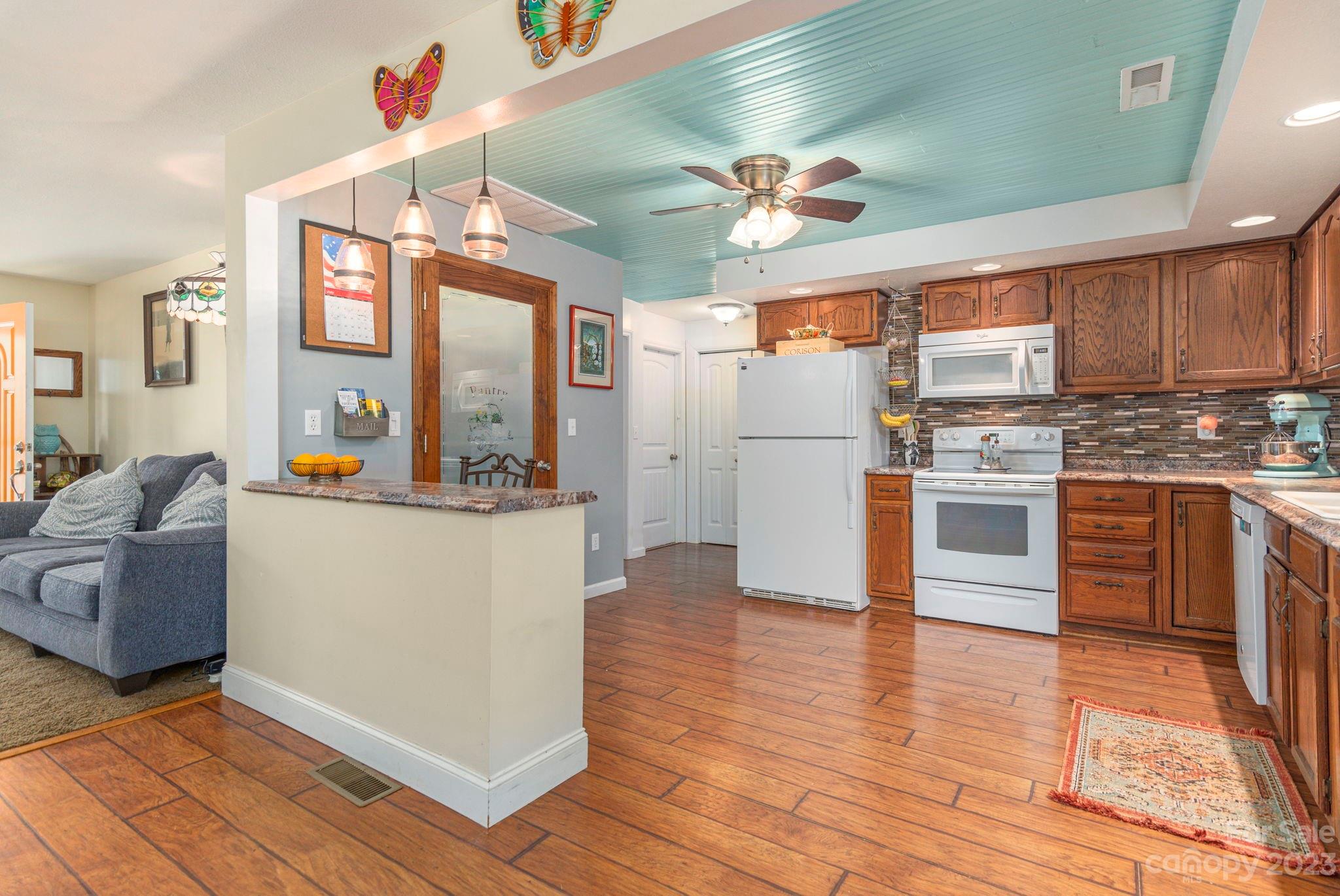 64 Israel Road Canton, NC 28716 - Photo 8 of 22 a kitchen with stainless steel appliances granite countertop a refrigerator a stove and a wooden floors