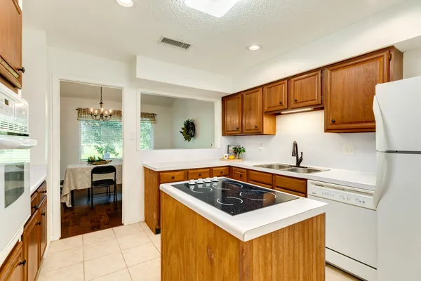 a kitchen with stainless steel appliances a stove sink and cabinets