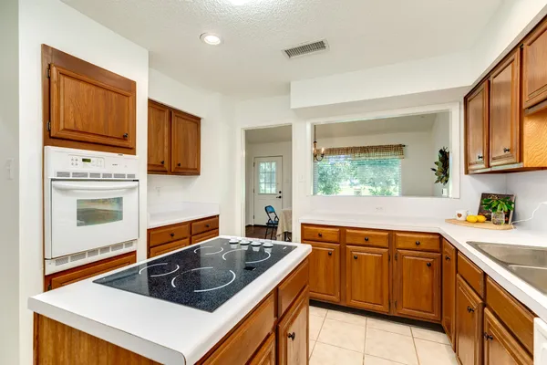 a kitchen that has a sink and a stove in it