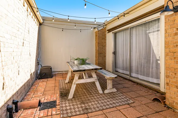 a roof deck with table and chairs and wooden floor