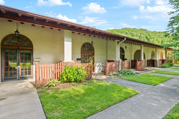 a front view of a house with garden