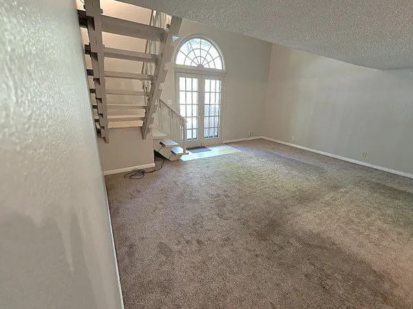 an empty room with windows and closet