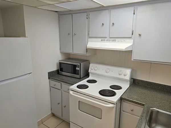 a kitchen with a stove and a refrigerator