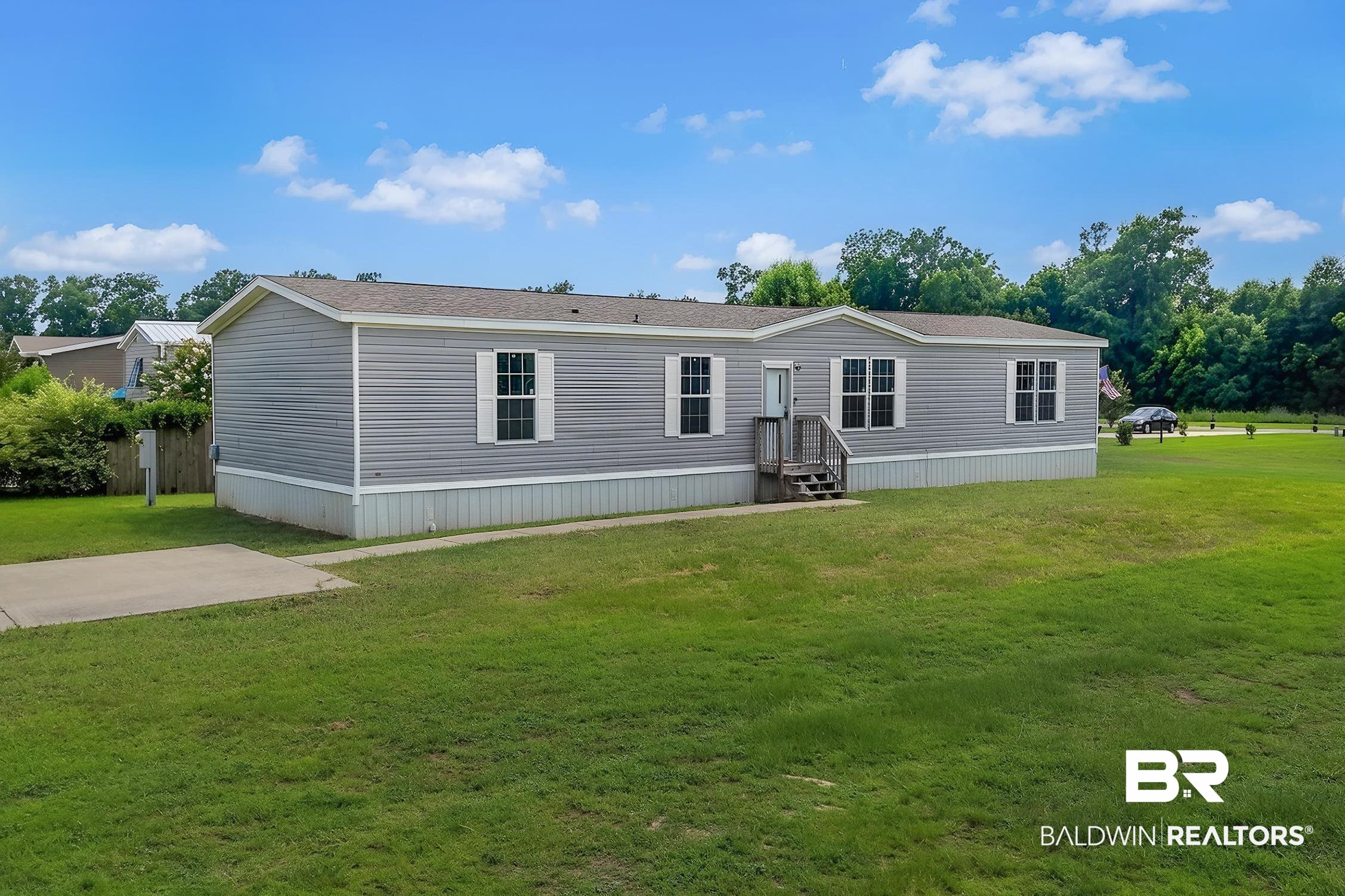 21601 Westside Loop Silverhill, AL 36576 - Photo 6 of 42 Single-story residence featuring gray horizontal siding and white window shutters