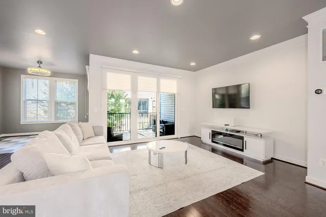 a living room with furniture fireplace and a flat screen tv