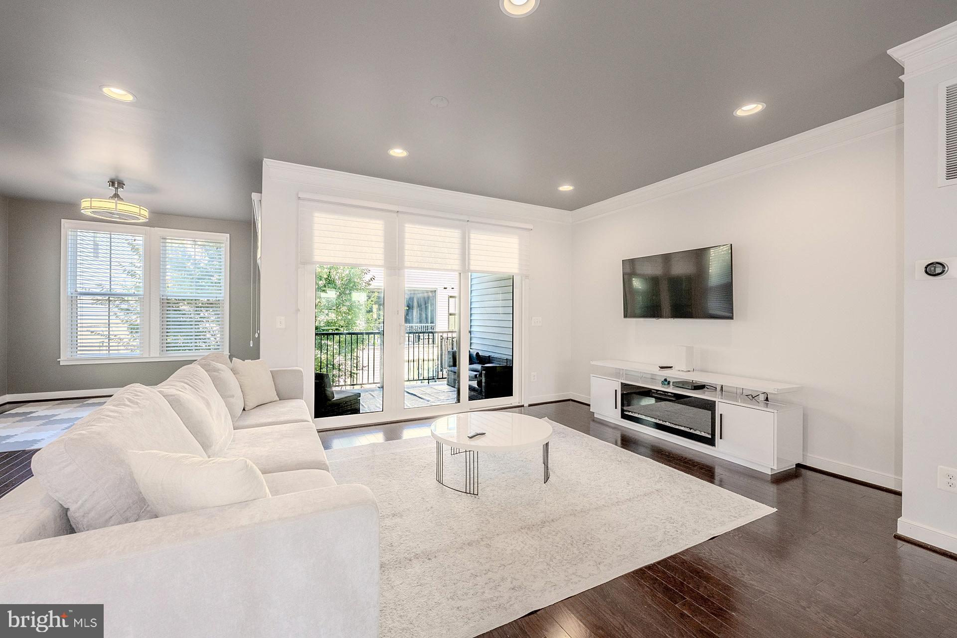 42298 Impervious Terrace Brambleton, VA 20148 - Photo 12 of 39 a living room with furniture fireplace and a flat screen tv