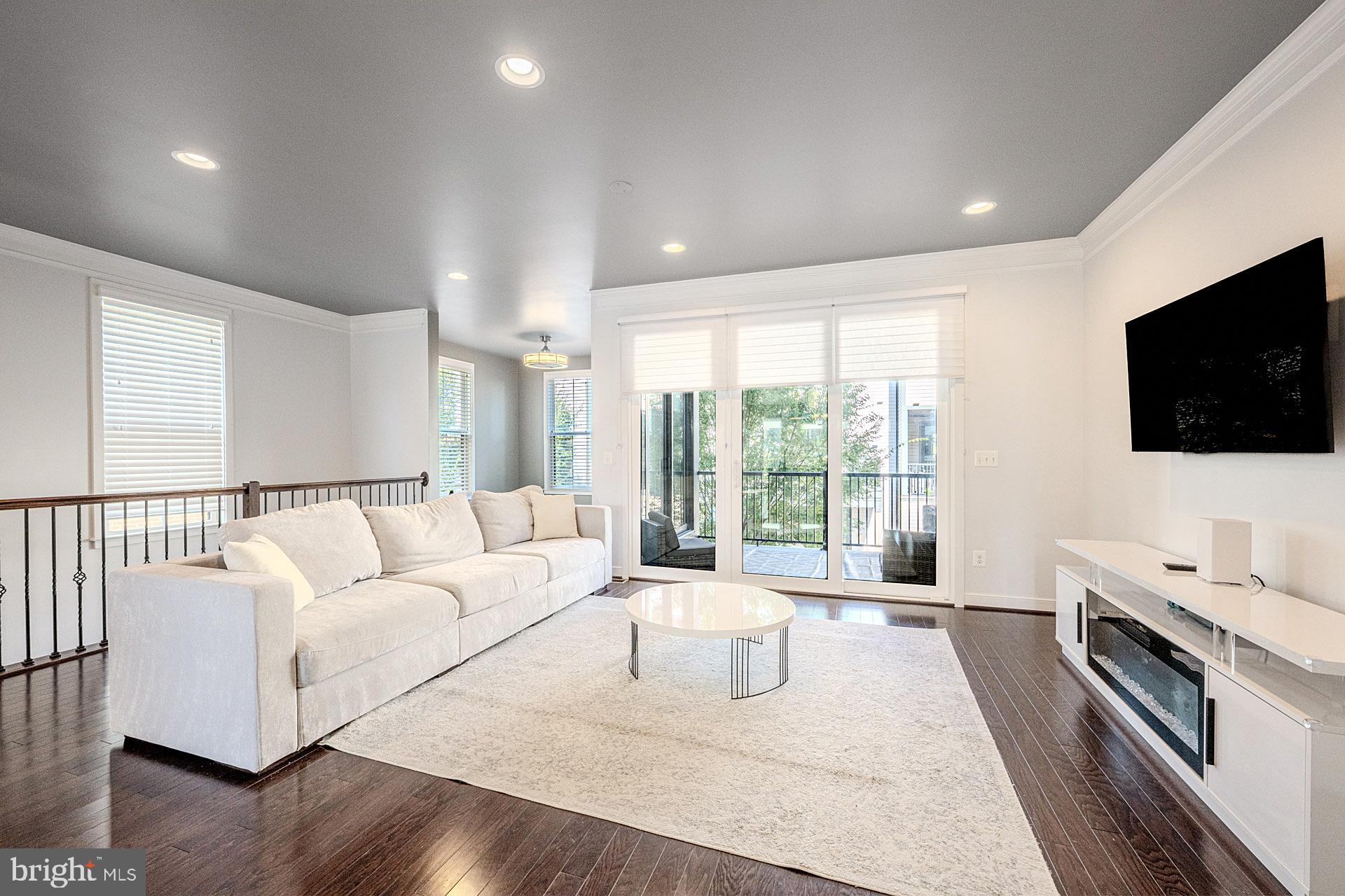 42298 Impervious Terrace Brambleton, VA 20148 - Photo 13 of 39 a living room with furniture and a flat screen tv