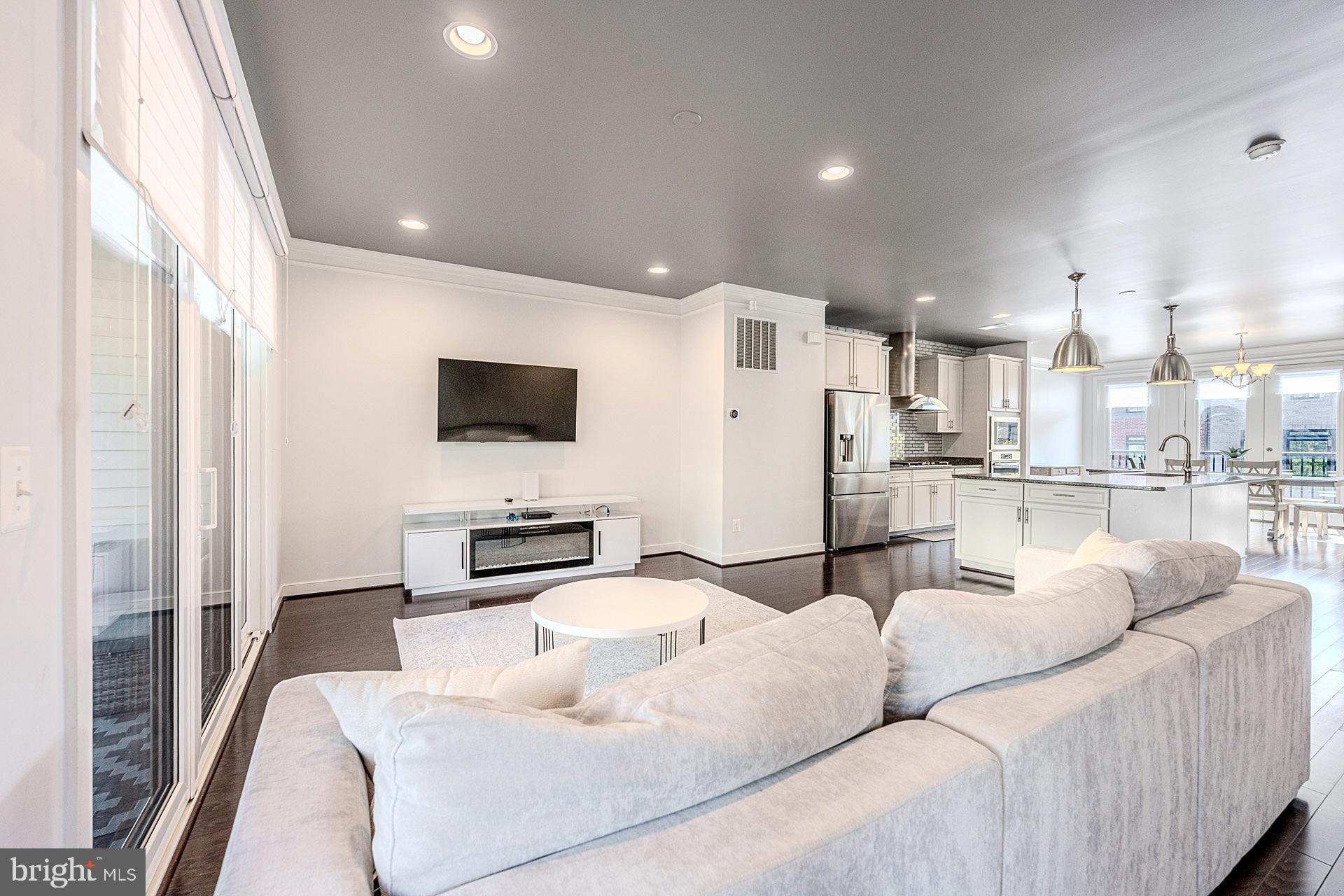 42298 Impervious Terrace Brambleton, VA 20148 - Photo 14 of 39 a living room with furniture and a flat screen tv