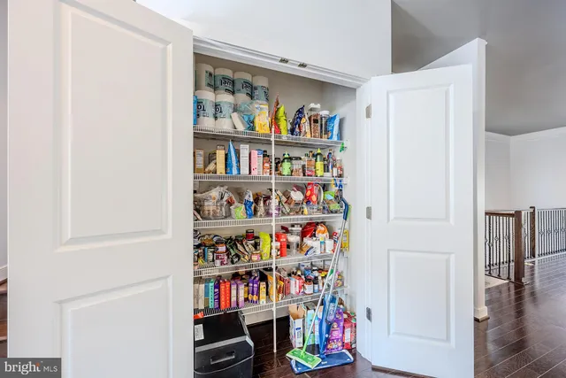 a room with book shelf and a painting on the wall
