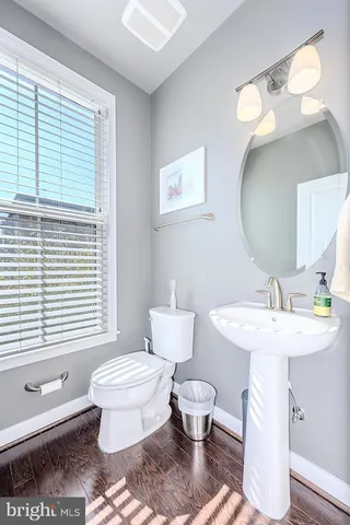 a bathroom with a toilet a sink and a mirror