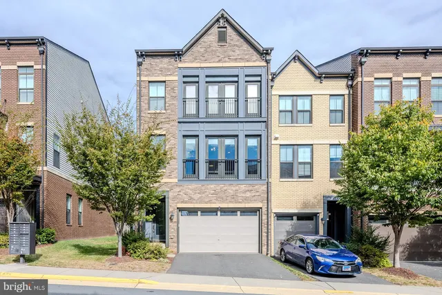 a car parked in front of a white building