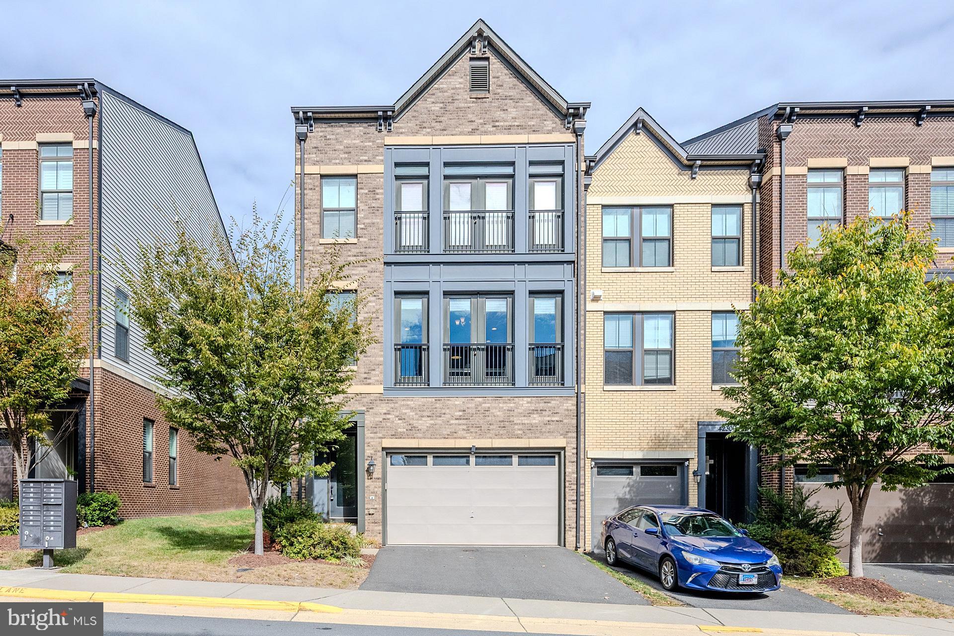 42298 Impervious Terrace Brambleton, VA 20148 - Photo 2 of 39 a car parked in front of a white building