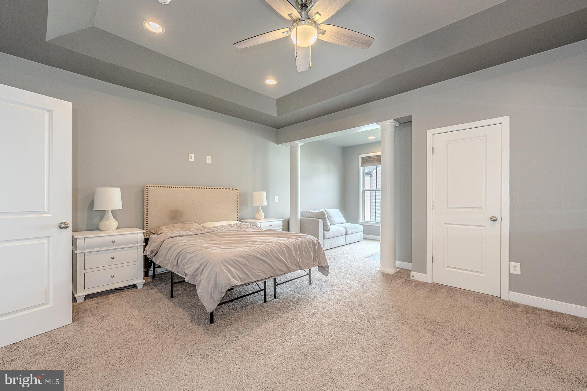 42298 Impervious Terrace Brambleton, VA 20148 - Photo 22 of 39 a spacious bedroom with a bed and a chandelier