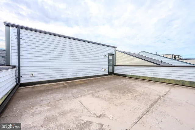 a white house that has tree in front of it