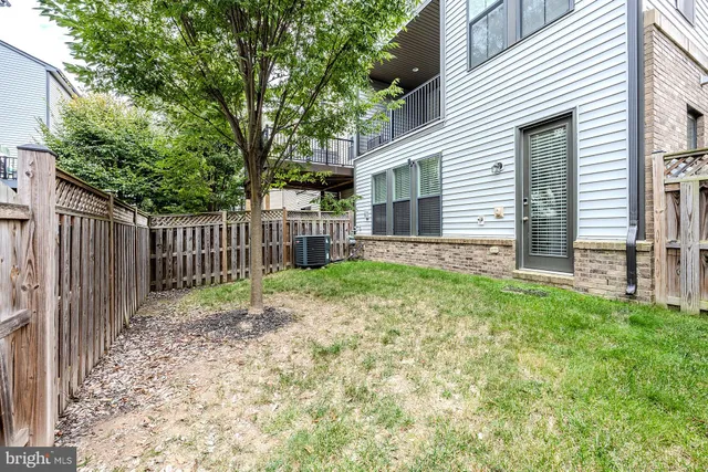 a view of a house with a wooden fence