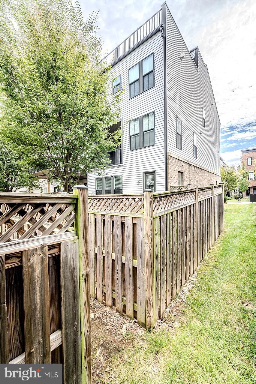 42298 Impervious Terrace Brambleton, VA 20148 - Photo 39 of 39 a view of a house with a wooden fence