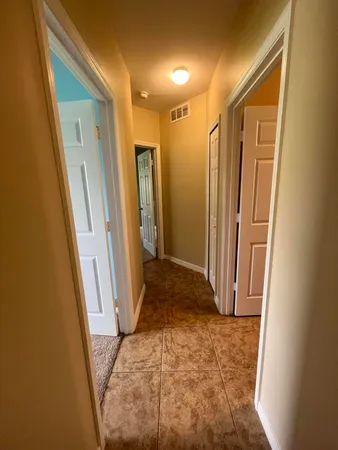 a bathroom with a granite countertop toilet sink and mirror