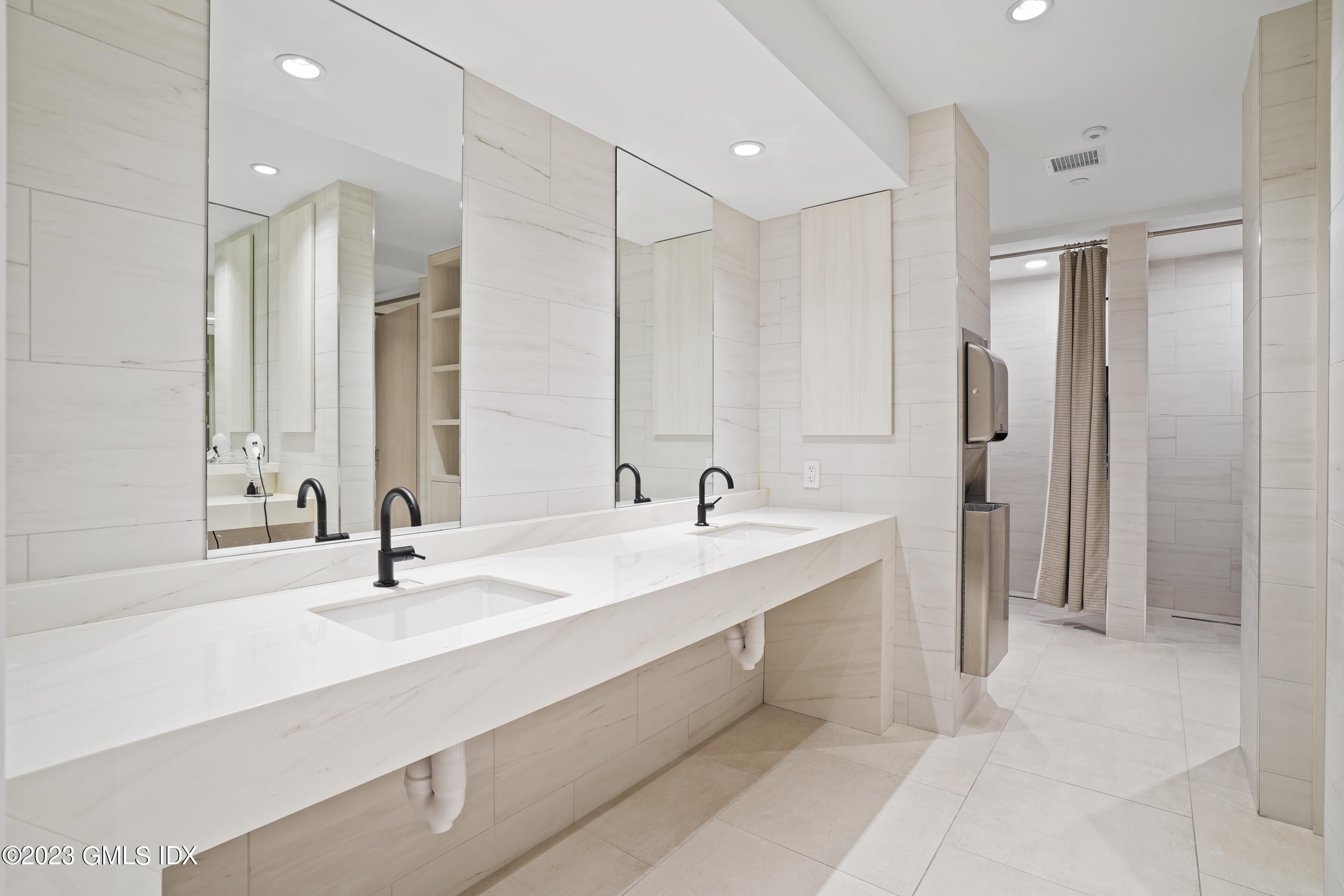 89 River Road, Unit 302 Cos Cob, CT 06807 - Photo 17 of 24 a bathroom with a double vanity sink mirror and double