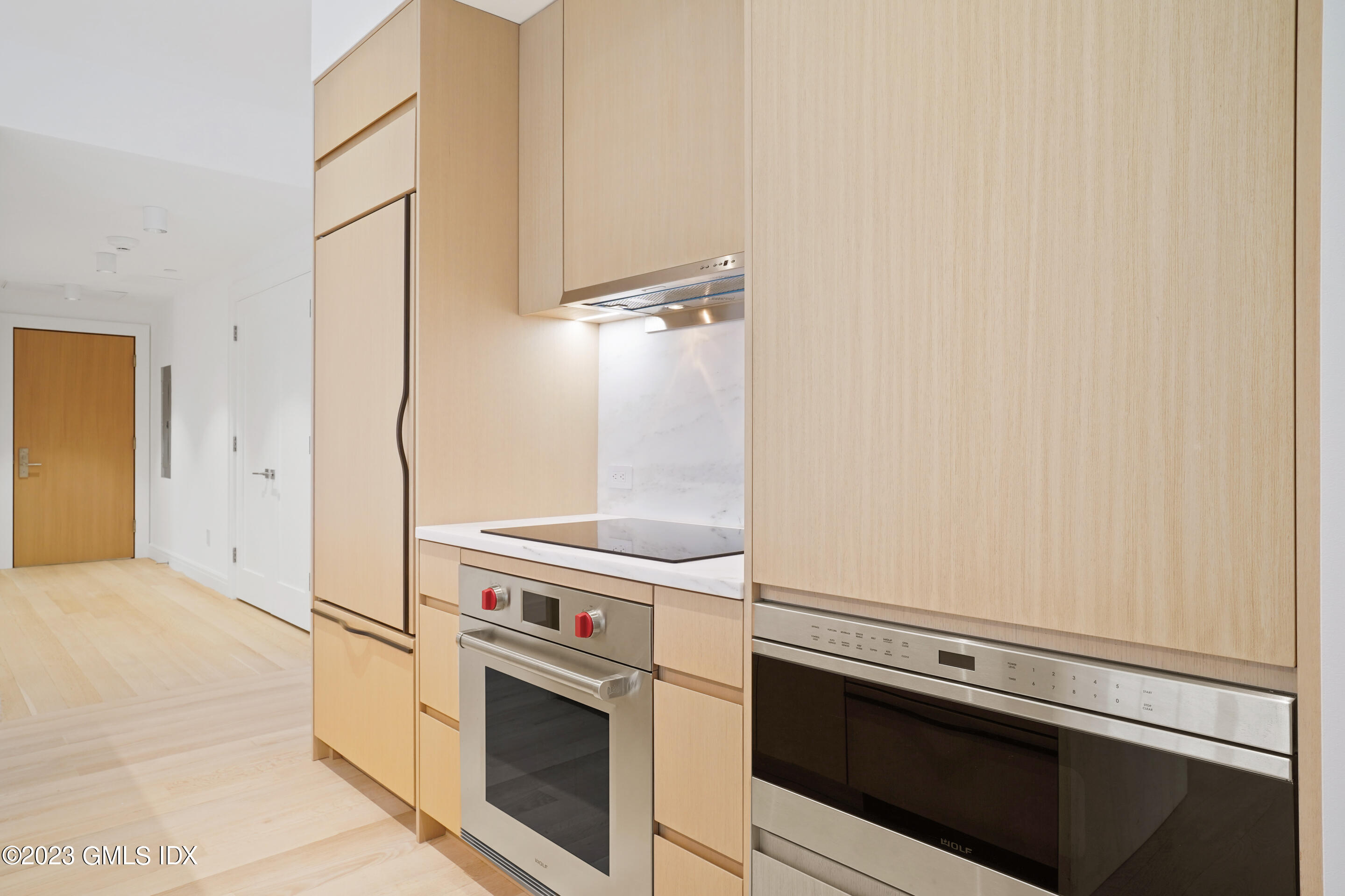 89 River Road, Unit 302 Cos Cob, CT 06807 - Photo 5 of 24 a kitchen with a stove and a refrigerator