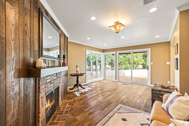 460 Omni Point Road Central Valley, UT 84754 - Photo 19 of 101 Brick fireplace with a wood-plank accent wall and floating mantel