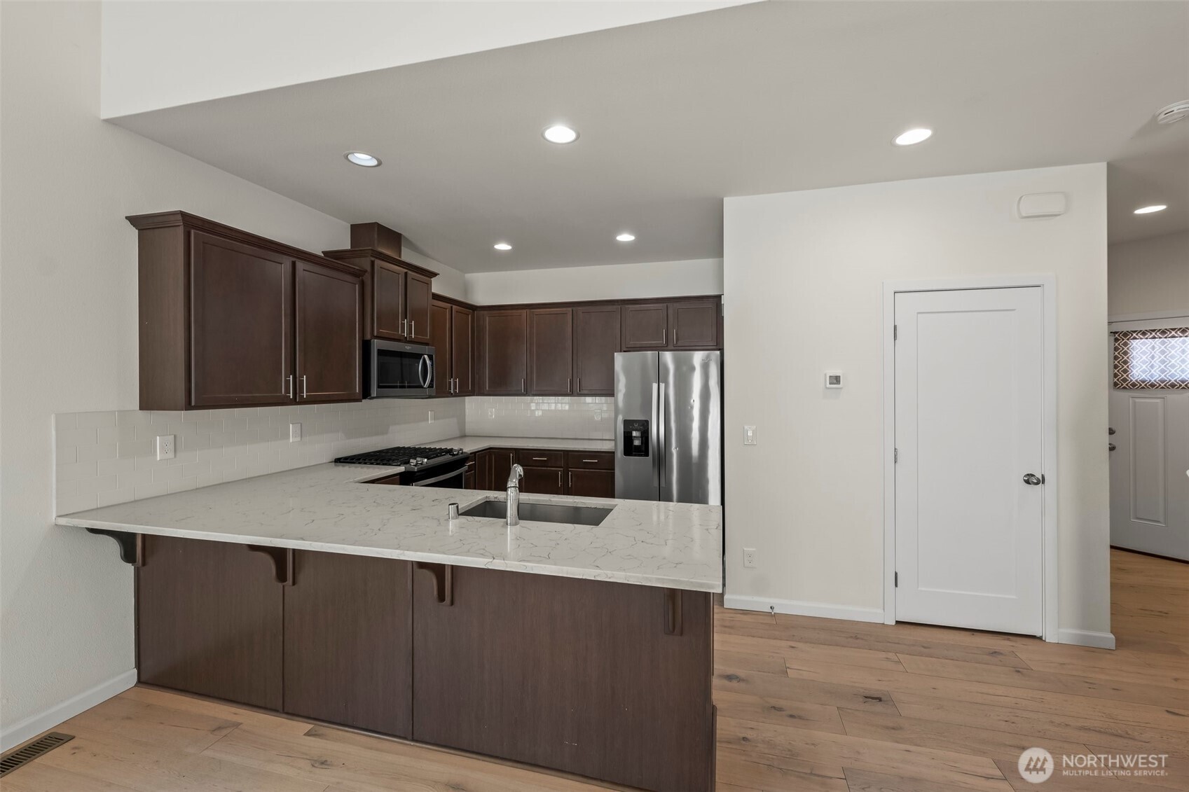 1080 East Old Ranch Road, Unit A1A2 Allyn, WA 98524 - Photo 21 of 35 a kitchen with stainless steel appliances granite countertop a refrigerator a sink and a stove