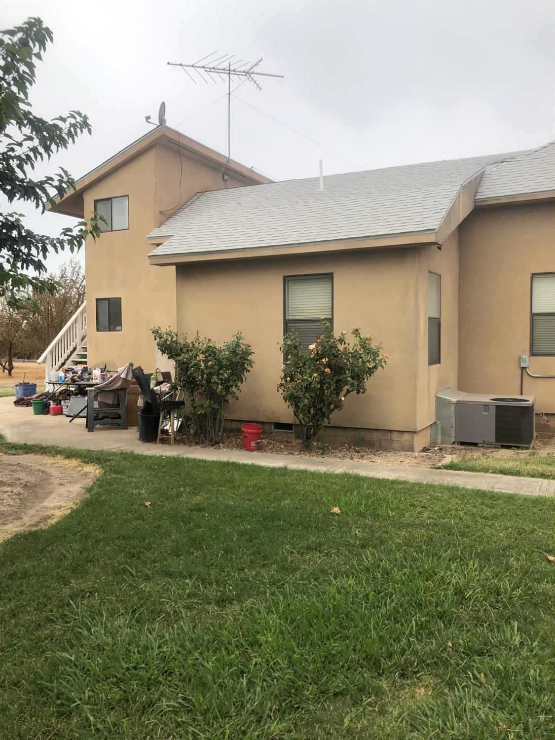 1313 South Stearns Road Oakdale, CA 95361 - Photo 11 of 57 a front view of a house with a yard and garage