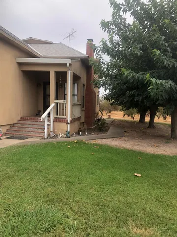 a front view of a house with yard patio and green space