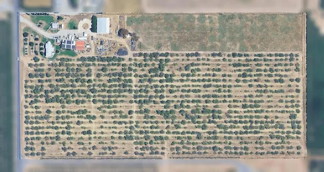 an aerial view of residential house with outdoor space and parking