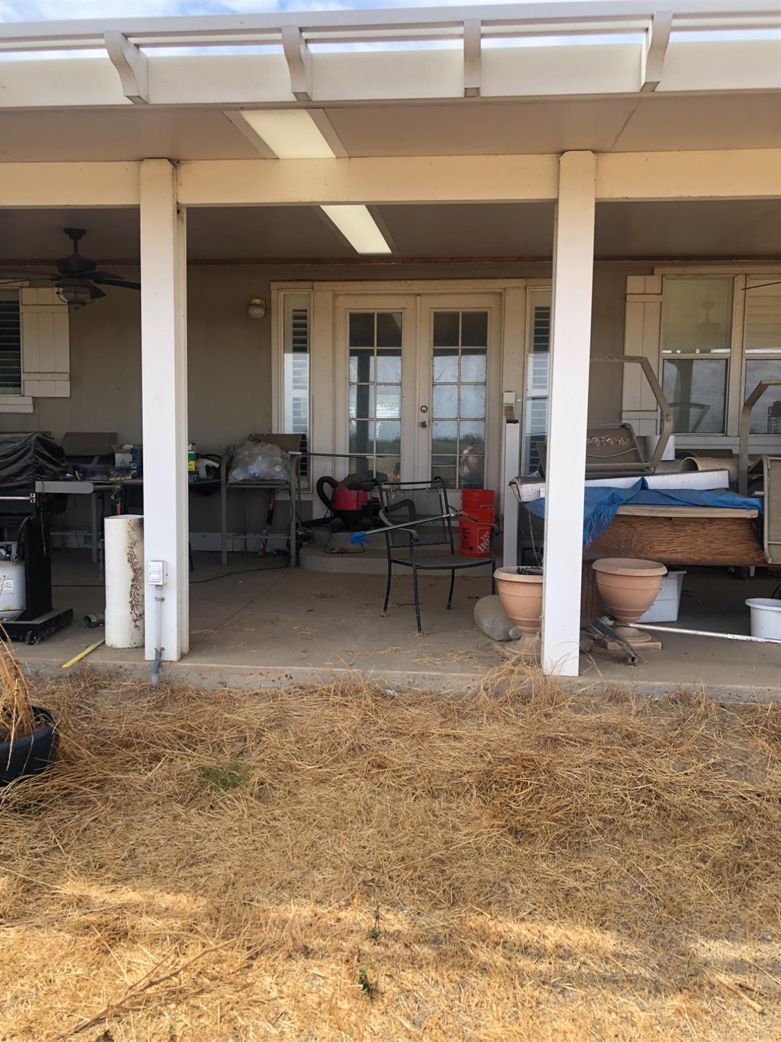 1313 South Stearns Road Oakdale, CA 95361 - Photo 24 of 57 view of back patio with French doors and ceiling fan