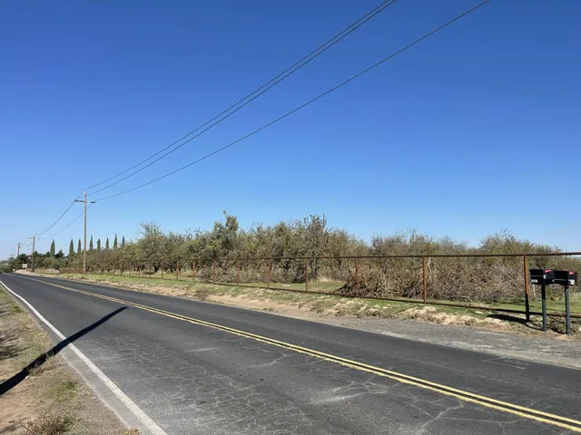 a view of a house with a backyard and sitting area