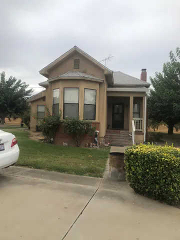 a view of a big house with a balcony