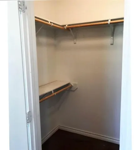 a view of a hallway with a wooden walls