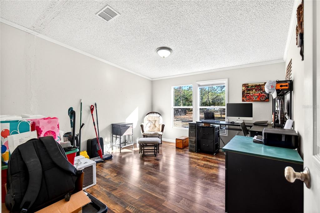 17087 Southwest 27 Street Dunnellon, FL 34432 - Photo 26 of 53 a living room with furniture and a flat screen tv