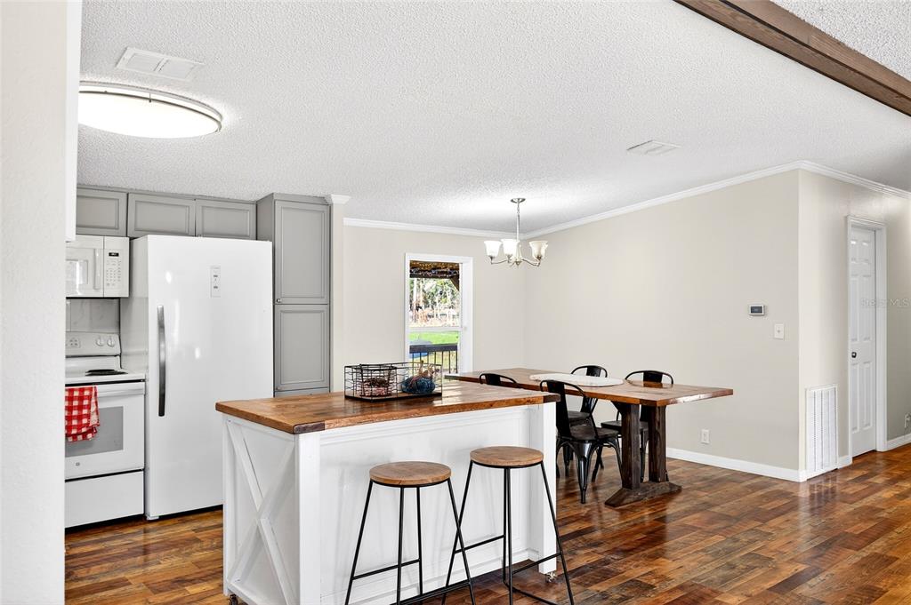 17087 Southwest 27 Street Dunnellon, FL 34432 - Photo 7 of 53 a kitchen with stainless steel appliances a white stove top oven and a refrigerator