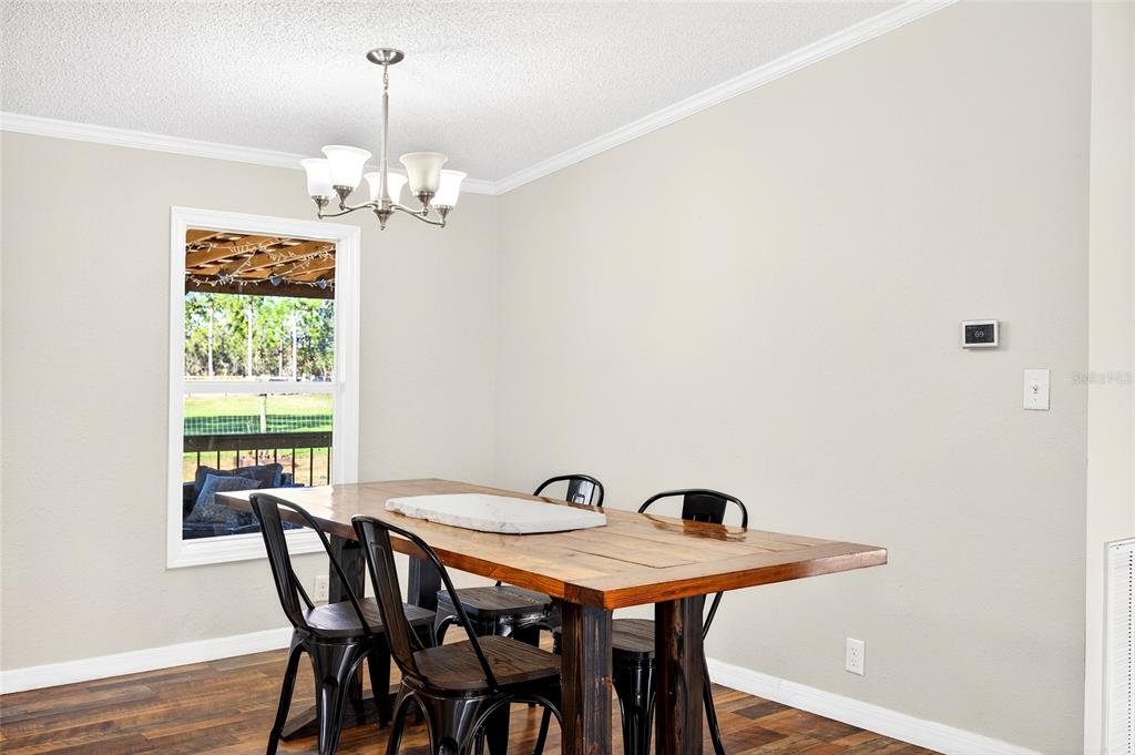 17087 Southwest 27 Street Dunnellon, FL 34432 - Photo 10 of 53 a view of a dining room with furniture and chandelier
