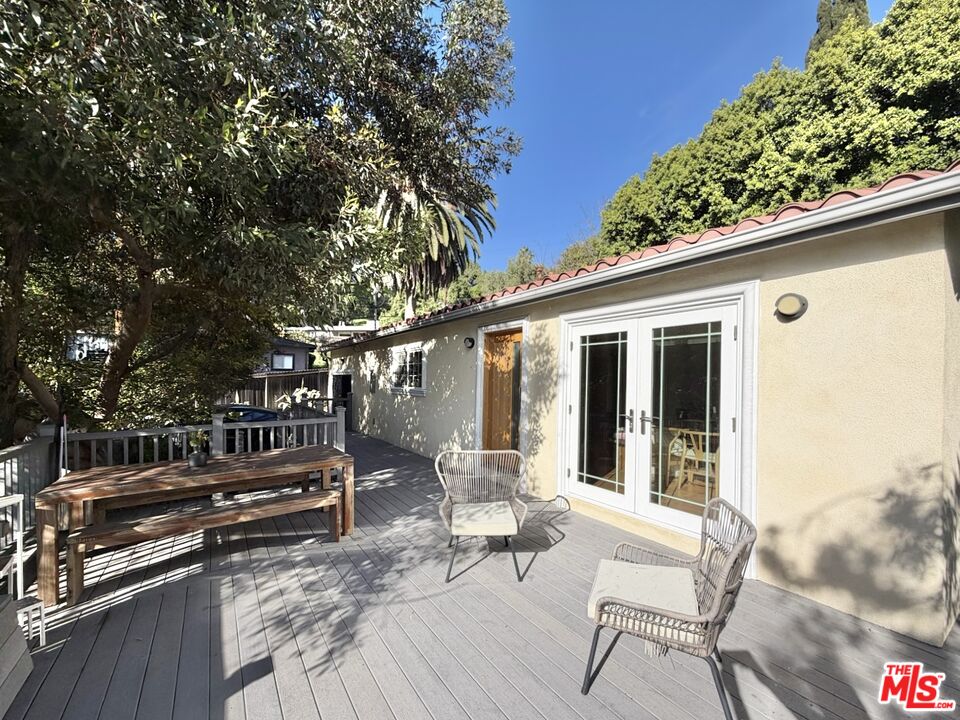 640 Rome Drive Los Angeles, CA 90065 - Photo 5 of 20 a view of patio with table and chairs and potted plants with wooden floor and fence